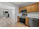 Galley kitchen features stainless steel appliances, wood cabinets and breakfast bar overlooking the living area at 4539 Fringetree Dr., Murrells Inlet, SC 29576