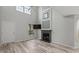 Bright living room with high ceilings, wood-look floors, a fireplace, and a large window for natural light at 4539 Fringetree Dr., Murrells Inlet, SC 29576