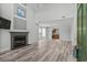 Bright living room featuring high ceilings, wood-look floors, fireplace, and an open view to the kitchen at 4539 Fringetree Dr., Murrells Inlet, SC 29576