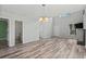 Open living space with wood-look floors and modern lighting fixtures, seamlessly connecting different living areas at 4539 Fringetree Dr., Murrells Inlet, SC 29576