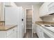 Efficient kitchen with white appliances, granite countertops, and ample storage, including a pantry for organized living at 4645 Fringetree Dr. # 10B, Murrells Inlet, SC 29576