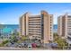 Multi-story condo building features a parking lot, neutral tones, and coastal views at 517 S Ocean Blvd. # 705, North Myrtle Beach, SC 29582