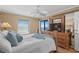 Serene bedroom features a wooden accent wall, ceiling fan, and a balcony showcasing ocean views at 517 S Ocean Blvd. # 705, North Myrtle Beach, SC 29582