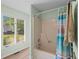 Bright bathroom featuring a shower with curtain, hardwood flooring and natural light from windows at 528 George Washington Trail, Georgetown, SC 29440