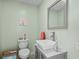 Half bathroom featuring a square sink, modern faucet, and pastel green walls at 528 George Washington Trail, Georgetown, SC 29440