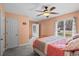 Comfortable bedroom featuring a ceiling fan, natural light, and gray carpeting at 528 George Washington Trail, Georgetown, SC 29440