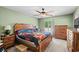 Bedroom with ceiling fan, wooden furniture, and cozy decor at 528 George Washington Trail, Georgetown, SC 29440