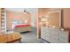 Bright bedroom featuring a ceiling fan, grey carpet, and a white dresser with decorative items at 528 George Washington Trail, Georgetown, SC 29440