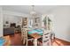 Dining area connects to living room with a wooden table, natural light, and hardwood floors at 528 George Washington Trail, Georgetown, SC 29440