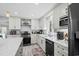 Bright kitchen with white cabinets, granite countertops, and stainless steel appliances at 528 George Washington Trail, Georgetown, SC 29440