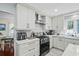 Updated kitchen featuring white cabinets, stainless steel appliances, and granite countertops at 528 George Washington Trail, Georgetown, SC 29440