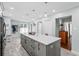 Kitchen island featuring gray cabinets, white granite countertops, and pendant lights at 528 George Washington Trail, Georgetown, SC 29440