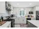 Modern kitchen featuring stainless steel appliances, white cabinets, and stylish backsplash at 528 George Washington Trail, Georgetown, SC 29440