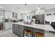 Open kitchen with gray island, stainless steel appliances, and modern finishes at 528 George Washington Trail, Georgetown, SC 29440