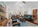 Spacious living room with vaulted ceilings, a brick fireplace, and cozy seating at 528 George Washington Trail, Georgetown, SC 29440