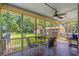 Relaxing screened porch with backyard view, seating area, and wooden floors at 528 George Washington Trail, Georgetown, SC 29440