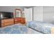 Shared bedroom space offering two twin beds with floral linens, and wooden dressers for storage at 609 Hillside Dr. S # D-17, North Myrtle Beach, SC 29582