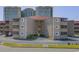 Exterior view of a multi-story building with multiple windows and parking spaces at 609 Hillside Dr. S # D-17, North Myrtle Beach, SC 29582