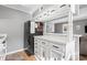 This kitchen has a breakfast bar and white countertops and cabinetry at 609 Hillside Dr. S # D-17, North Myrtle Beach, SC 29582