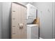 Efficient laundry area with stacked washer/dryer unit and a storage cabinet at 609 Hillside Dr. S # D-17, North Myrtle Beach, SC 29582