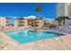 Community pool with brick paver deck and ample seating, palm trees, and a cabana at 609 Hillside Dr. S # D-17, North Myrtle Beach, SC 29582