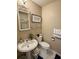 Small bathroom with toilet, sink, and framed art at 624 Dogwood Dr. S, Garden City Beach, SC 29576