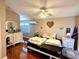 Cozy bedroom featuring hardwood floors, a ceiling fan, and a dresser for storage at 624 Dogwood Dr. S, Garden City Beach, SC 29576