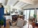 Dining and living room combo, with natural lighting, ceiling beams, hardwood floors, and modern decor at 624 Dogwood Dr. S, Garden City Beach, SC 29576