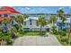 Inviting two-story home with a white exterior, waterfront views, a manicured lawn, and palm trees at 624 Dogwood Dr. S, Garden City Beach, SC 29576