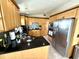 Bright kitchen features stainless steel appliances, tile floor, light wood cabinets, and dark countertops at 624 Dogwood Dr. S, Garden City Beach, SC 29576