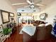 Relaxing living room area with hardwood floors, ceiling fan, a comfortable couch, and a side table at 624 Dogwood Dr. S, Garden City Beach, SC 29576