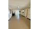 Open living area featuring neutral flooring, white wainscoting, and an open layout leading to the kitchen at 624 Dogwood Dr. S, Garden City Beach, SC 29576