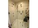Bathroom shower featuring multiple shower heads, grab bars and a shower chair at 624 Dogwood Dr. S, Garden City Beach, SC 29576