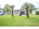 Expansive backyard with palm trees and a patio, perfect for outdoor entertaining at 654 Blue Bird Ln., Murrells Inlet, SC 29576