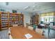 Large community library room featuring wood bookshelves and tables for reading at 654 Blue Bird Ln., Murrells Inlet, SC 29576