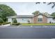 Charming building exterior featuring brick accents, well-maintained landscaping, and convenient golf cart parking at 654 Blue Bird Ln., Murrells Inlet, SC 29576