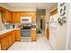 Well-lit kitchen with wood cabinets, stainless steel appliances, and tile flooring at 654 Blue Bird Ln., Murrells Inlet, SC 29576