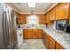 Well-lit kitchen with stainless steel appliances and wood cabinets at 654 Blue Bird Ln., Murrells Inlet, SC 29576