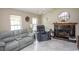 Cozy living room featuring a fireplace, plush seating, and abundant natural light at 654 Blue Bird Ln., Murrells Inlet, SC 29576