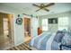 Relaxing bedroom with ceiling fan, TV, and a view into the bathroom at 654 Blue Bird Ln., Murrells Inlet, SC 29576