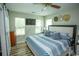 Inviting bedroom with great natural light, TV, and wood-look flooring at 654 Blue Bird Ln., Murrells Inlet, SC 29576