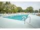 A refreshing outdoor community pool with ample seating and umbrellas for a relaxing experience at 654 Blue Bird Ln., Murrells Inlet, SC 29576