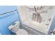 Bathroom featuring a toilet with starfish decor and a bathtub with a shower curtain, all in a blue-themed space at 7200 N Ocean Blvd. # 1160, Myrtle Beach, SC 29572