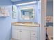Well-lit bathroom features a vanity with a granite countertop and a modern mirror, complemented by fresh towels and decor at 7200 N Ocean Blvd. # 1160, Myrtle Beach, SC 29572
