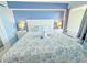 Cozy bedroom featuring a queen bed with beach-themed decor and bedside tables with lamps at 7200 N Ocean Blvd. # 1160, Myrtle Beach, SC 29572