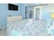 Bright bedroom boasts a comfortable bed, stylish dresser, and a peek into the kitchen through a sliding mirrored door at 7200 N Ocean Blvd. # 1160, Myrtle Beach, SC 29572