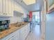 Bright kitchen with white cabinets, granite counters, and stainless steel appliances, offering a view to the living area and ocean at 7200 N Ocean Blvd. # 1160, Myrtle Beach, SC 29572