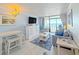 Bright living room with dining area, comfortable seating, and an ocean view balcony at 7200 N Ocean Blvd. # 1160, Myrtle Beach, SC 29572