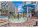 Splash pool with water features and slides and blue water surrounded by seating and palm trees at 7200 N Ocean Blvd. # 1160, Myrtle Beach, SC 29572