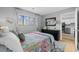 Charming bedroom with large window, dresser, and colorful bedding, offering a cozy retreat at 7700 Porcher Dr. # 3207, Myrtle Beach, SC 29572